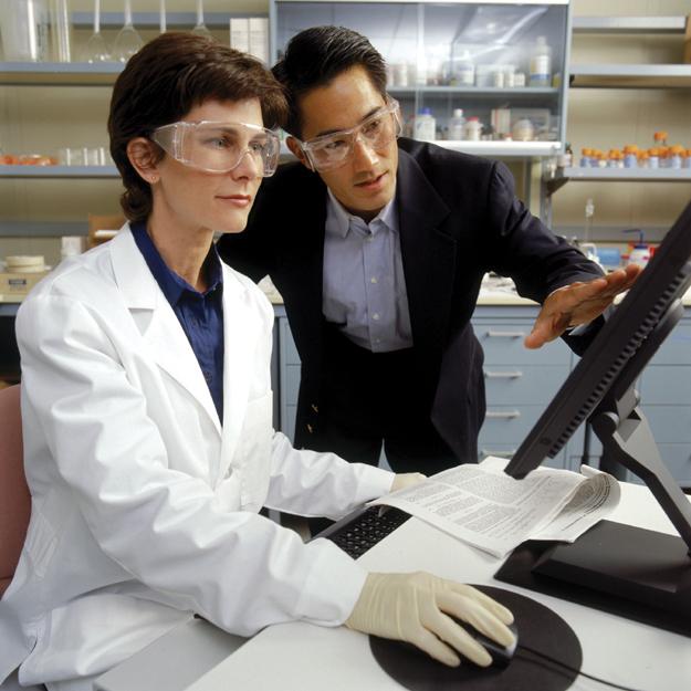 Lab scientists analysing results on a computer